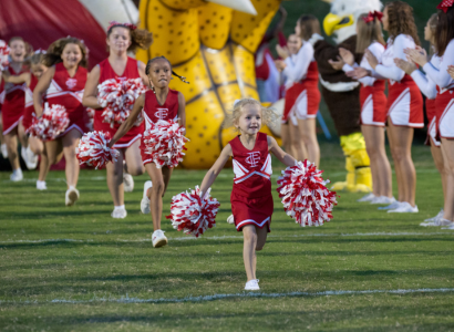 Cheerleaders Running Onto Football Field