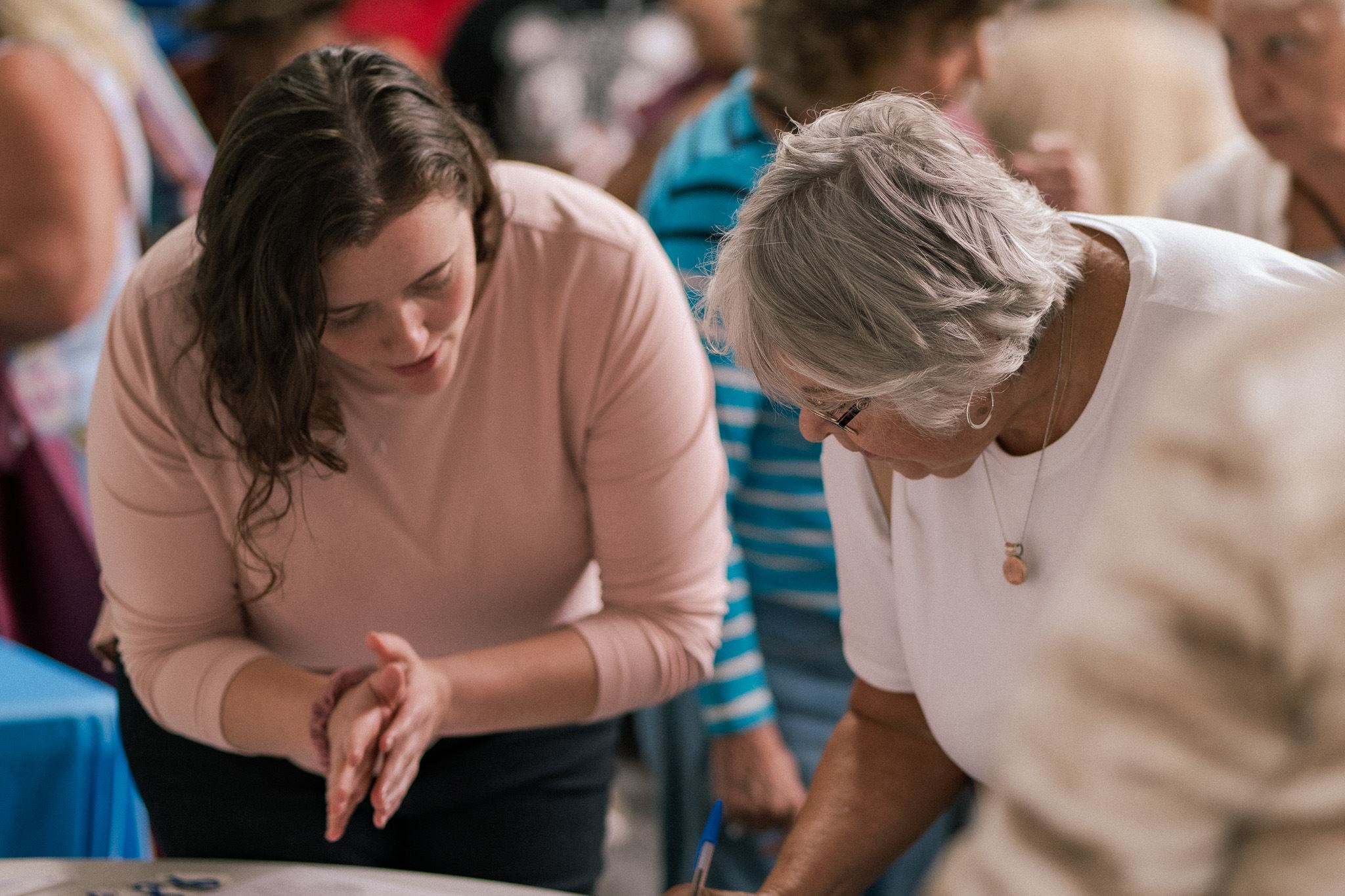 Two people talking as they discuss information at a table 
